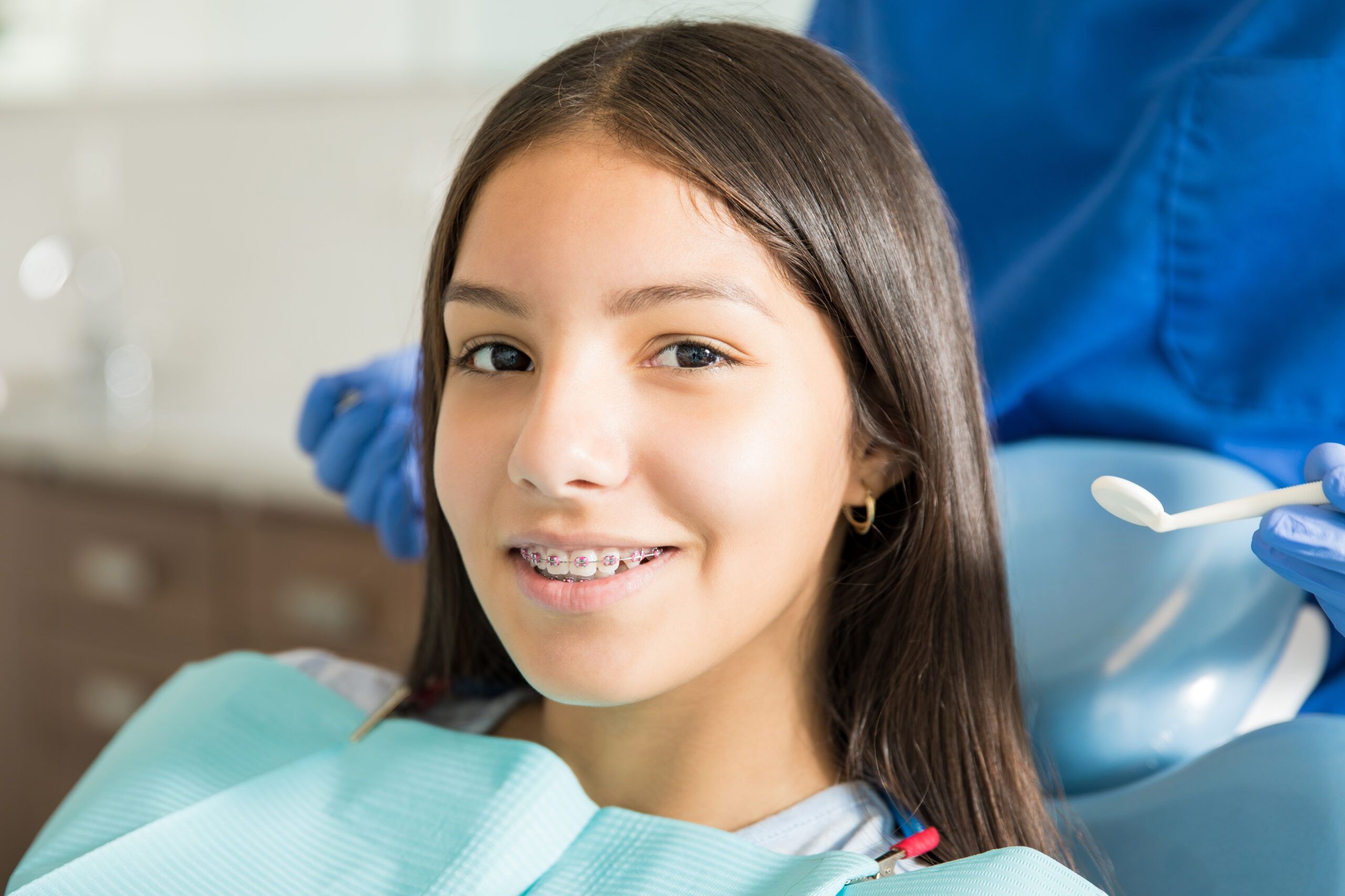 young girl smiling with braces on